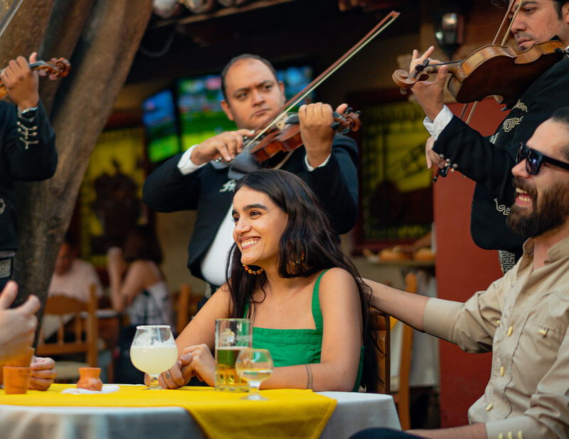 Woman at lunch with a mariachi band playing